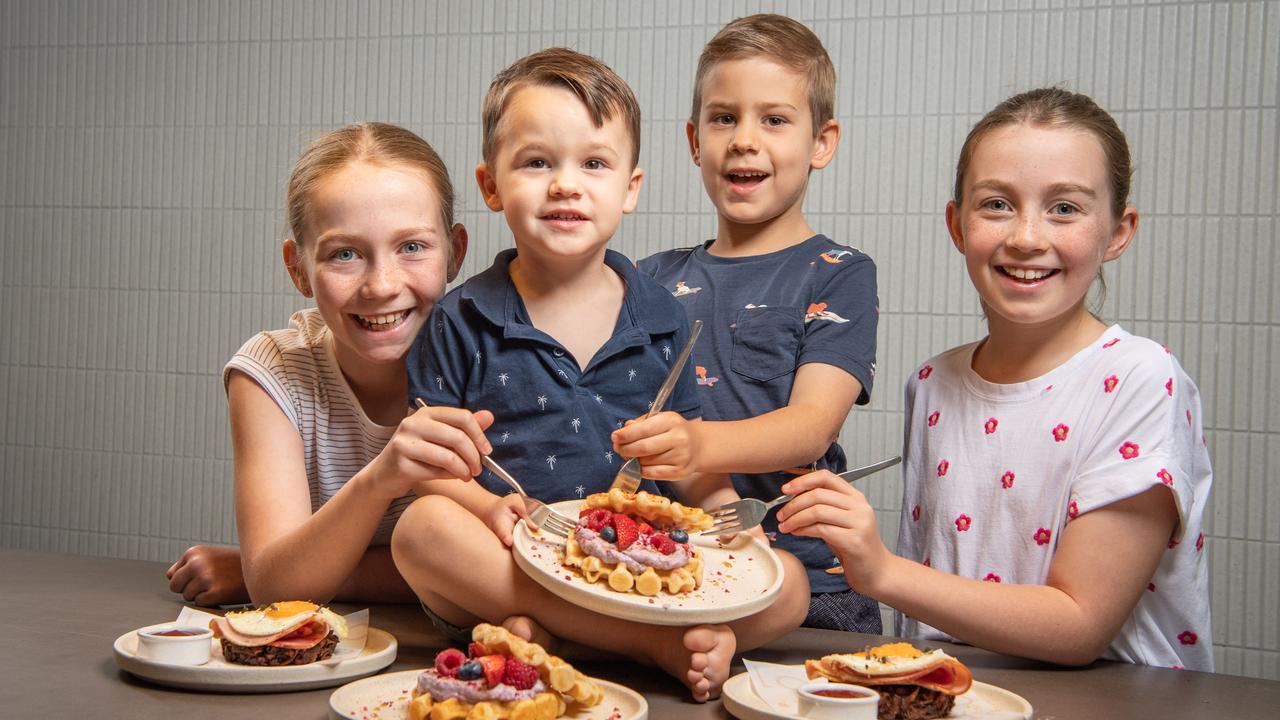 Zoe Munro, 12, Benjamin Raethke, 2, Ethan Raethke, 5, and Lucy Munro, 10, try out some healthy breakfasts from Nodo cafe in Newstead. Picture: Brad Fleet