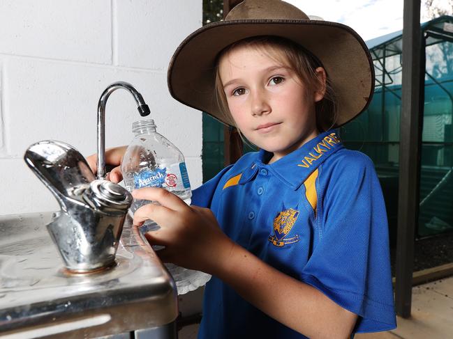 Year 4 student Lacey Hanrahan at the non-functioning water bubbler at Valkyrie State School. Picture: Tara Croser