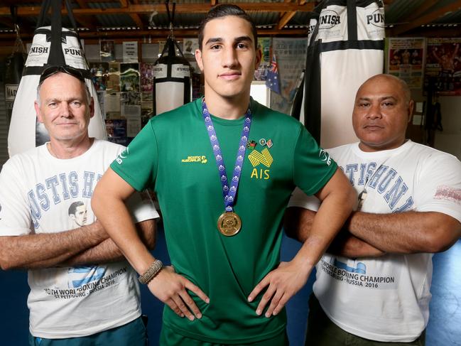 Justsis Huni at 17 and, the world amateur boxing champion, in his hometown of Logan, pictured with Dad Rocki Huni and trainer Mark Wilson. Picture: Jono Searle