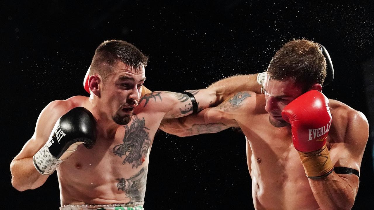 Toowoomba’s Brent Rice (right) and Gaige Ireland fight out a draw in last night’s Australian lightweight title fight at the Melbourne Pavilion in Melbourne. PICTURE: AAP Image/Scott Barbour.