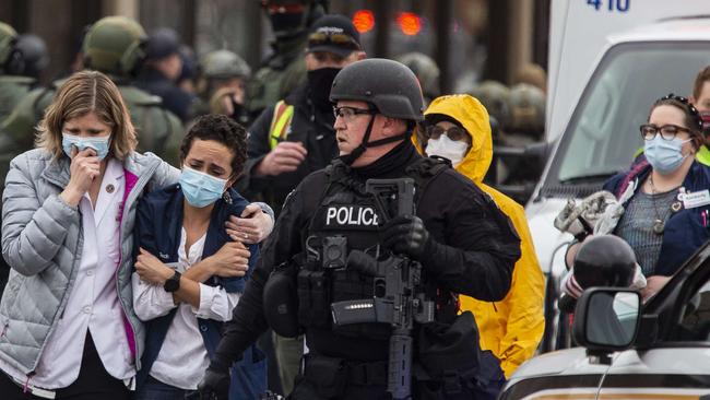 Workers are escorted from the King Soopers supermarket in Boulder County, Colorado, following the shooting that left at least 10 dead. Picture: AFP