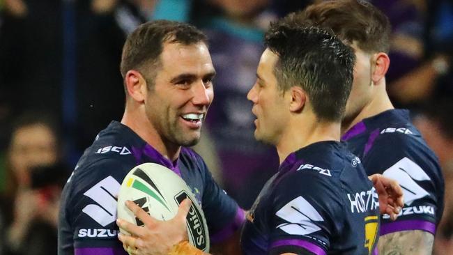 Cooper Cronk is congratulated by Cameron Smith after scoring a try.