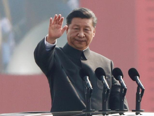 Chinese President Xi Jinping waves from a vehicle as he reviews the troops at a military parade marking the 70th founding anniversary of People's Republic of China, on its National Day in Beijing, China October 1, 2019.  REUTERS/Thomas Peter