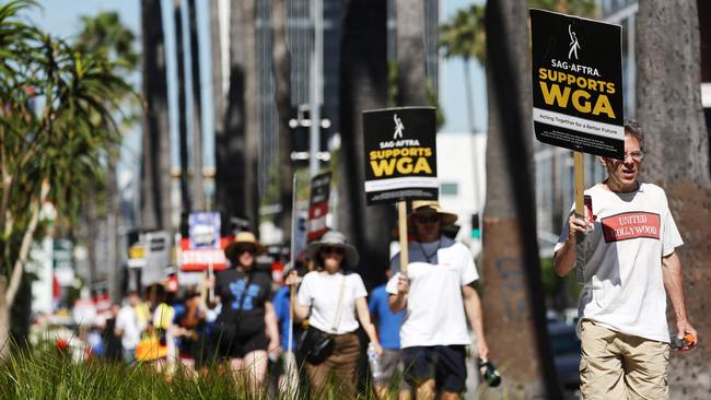 A sign reads 'SAG-AFTRA Supports WGA' as SAG-AFTRA members walk the picket line in solidarity with striking Writers Guild of America workers outside Netflix offices on July 13, 2023 in Los Angeles, California. Picture: Getty Images