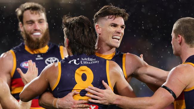 ADELAIDE, AUSTRALIA - JUNE 06: Ben Keays of the Crows hugs Josh Rachele of the Crows after he kicked a goal during the 2025 AFL Round 13 match between the Adelaide Crows and the Brisbane Lions at Adelaide Oval on June 6, 2025 in Adelaide, Australia. (Photo by Sarah Reed/AFL Photos via Getty Images)