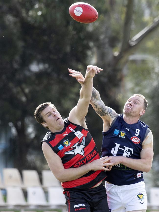 Lauderdale ruckman Haydn Smith clashes with Launceston playing coach Mitch Thorp. Picture Chris Kidd