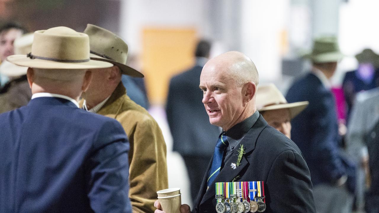 Craig Walker chats to mates before marching to the Anzac Day dawn service, Monday, April 25, 2022. Picture: Kevin Farmer