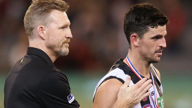 MELBOURNE, AUSTRALIA - APRIL 25: Magpies head coach Nathan Buckley walks off with best afield Scott Pendlebury of the Magpies after he was jeered by Bombers fans on receiving his medal during the round 6 AFL match between Essendon and Collingwood at Melbourne Cricket Ground on April 25, 2019 in Melbourne, Australia. (Photo by Michael Dodge/Getty Images)