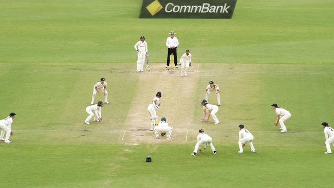 The Australian team surrounds the bat as England’s Kate Cross blocks out the final ball. Picture: Mark Kolbe/Getty Images