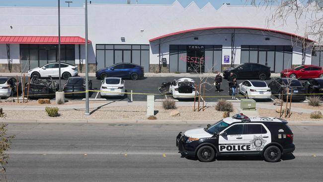 Investigators examine the scene at a Tesla Collision Centre after an individual used incendiary devices to set several vehicles on fire on March 18 in Las Vegas, Nevada. Picture: Getty Images via AFP