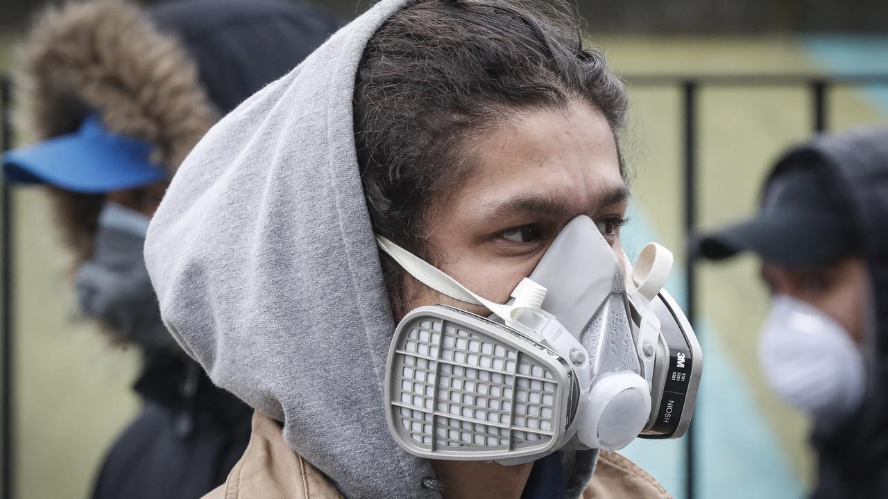 A man wears personal protective equipment as he waits to enter a COVID-19 testing site at Elmhurst Hospital Centre in New York on Wednesday, March 25, 2020. Picture: John Minchillo/AP
