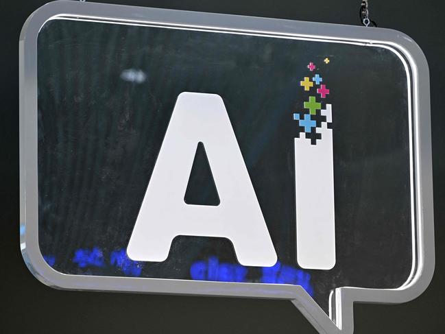 (FILES) This photograph shows an AI (artificial intelligence) logo at the Mobile World Congress (MWC), the telecom industry's biggest annual gathering, in Barcelona on February 27, 2024. Apps infused with AI are being marketed to schools across the world and governments are rushing to embrace the technology, despite experts raising serious doubts. (Photo by Josep LAGO / AFP)