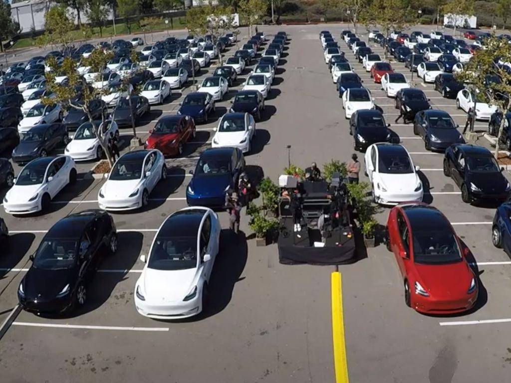 Tesla investors socially distance inside their cars.