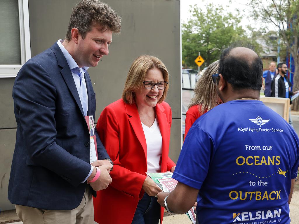 Ms Allan and Mr Lister greet a voter. Picture: Ian Currie