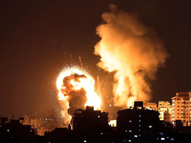 TOPSHOT - Fire billow from Israeli air strikes in the Gaza Strip, controlled by the Palestinian Islamist movement Hamas, on May 10, 2021. - Israel launched deadly air strikes on Gaza in response to a barrage of rockets fired by the Islamist movement Hamas amid spiralling violence sparked by unrest at Jerusalem's Al-Aqsa Mosque compound. (Photo by MAHMUD HAMS / AFP)