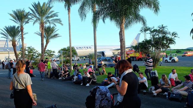 Passengers at the airport in New Caledonia after being forced to evacuate a United flight travelling from Melbourne to LA. Picture: Nathan Lanier