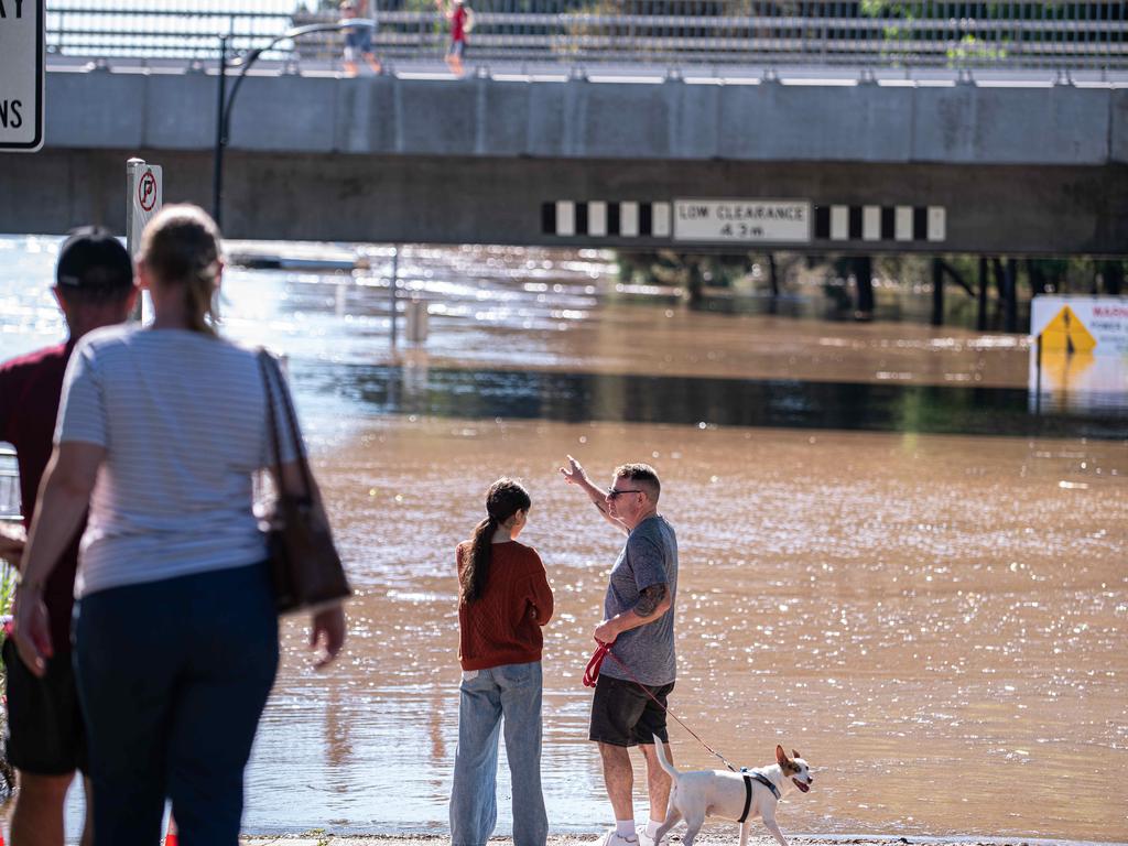 People watch on as the water level approaches the bottom of the Windsor Bridge on Saturday afternoon. Picture: Flavio Brancaleone