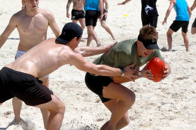 Rhys King (right) about to be tackled during the Southport Sharks VFL team during a preseason training camp at Tallebudgera Beach. Picture: Mike Batterham