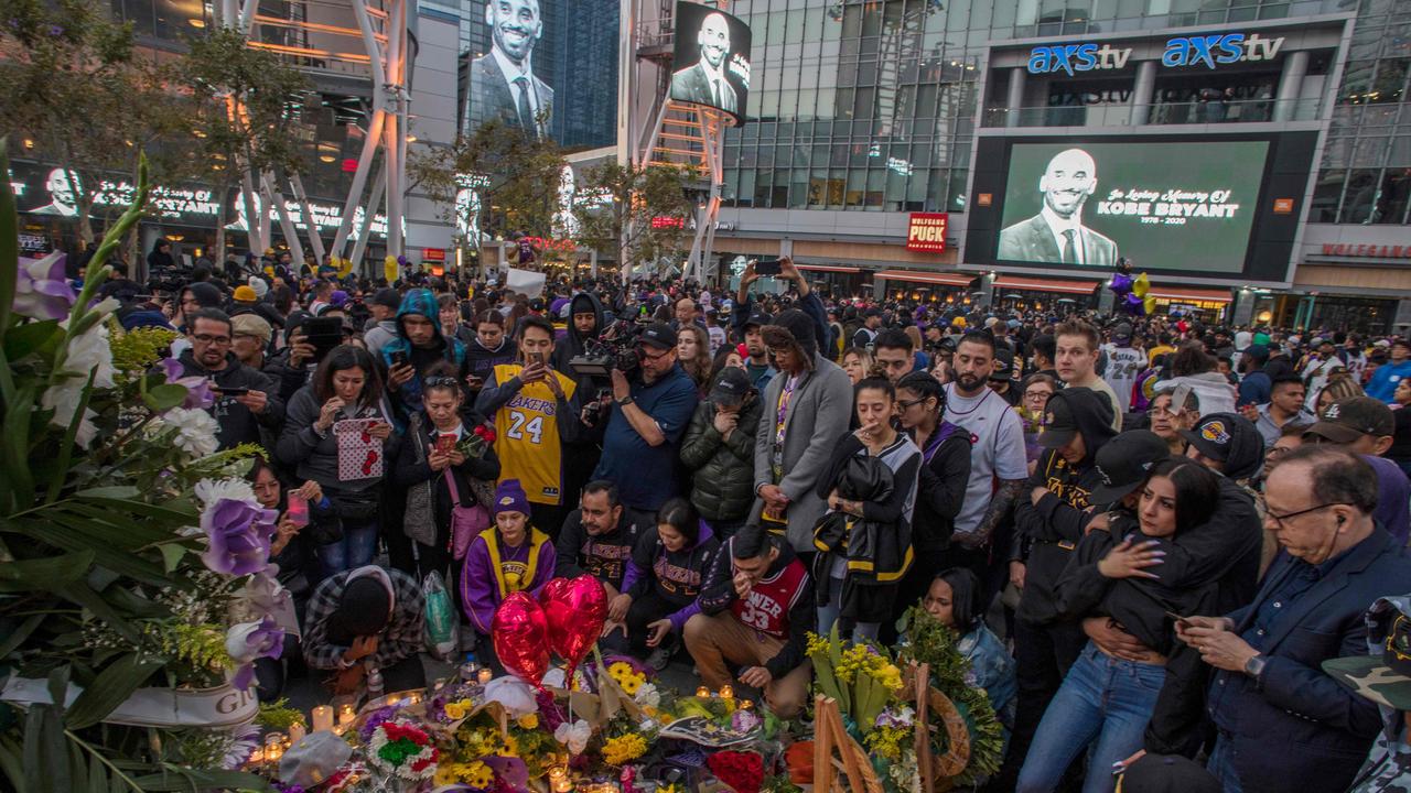 People gathered around a makeshift memorial for Bryant in front of Staples Center in Los Angeles on Sunday night. Picture: AFP/Apu Gomes