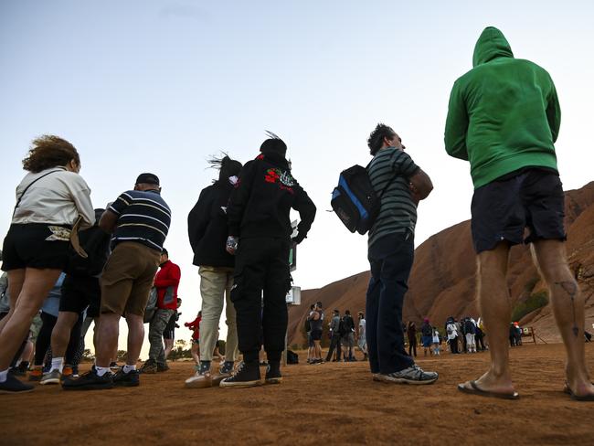 Tourists are seen climbing Uluru, also known as Ayers Rock at Uluru-Kata Tjuta National Park in the Northern Territory on the last day. Picture: AAP