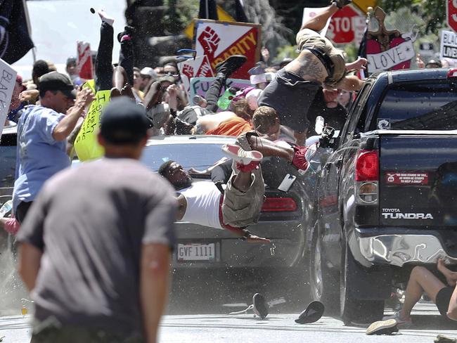 People fly into the air as a vehicle drives into a group of protesters demonstrating against a white nationalist rally in Charlottesville. Picture: Ryan M. Kelly/The Daily Progress/AP