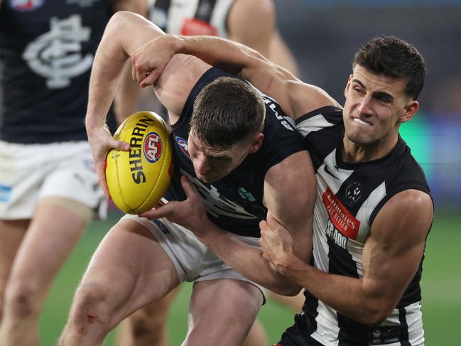 Nick Daicos tackles Carlton star Sam Walsh, who helped bring the Blues right back into the game. Picture: Daniel Pockett/Getty Images