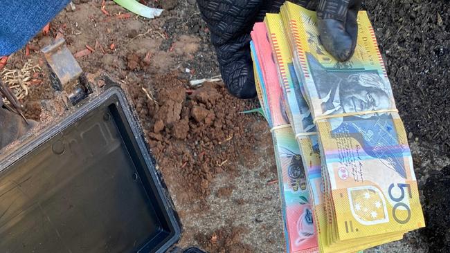 More than $50,000 was allegedly found buried at the Morphett Vale property. Picture: SA Police.