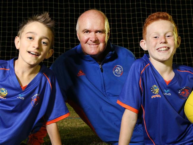 John Vander Veeken (President, Sturt Lions Football Club) of Hawthorndene, with Edwin De Haaij 11 of Trott Park (left) and James O'Toole 11 of Hawthorndene (right) (both Sturt Lions Football Club, Under 12's players), at Karinya Reserve, Eden Hills. Sturt Lions Football Club junior partipation numbers have had a dramatic increase over the past two years. They are training outside the Mitcham Council area, have been turning away players. 13/04/16  Picture: Stephen Laffer