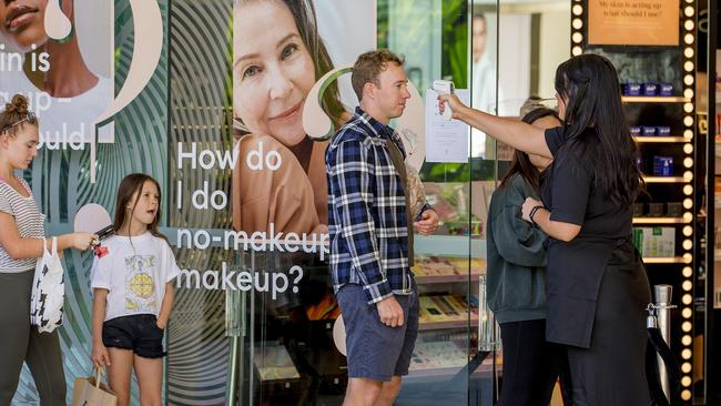 COVID-19 restrictions around shopping and go out in public have been relaxed. Shoppers being temperature checked before entering Mecca Maxima at Pacific Fair Shopping Centre in Broadbeach. Picture: Jerad Williams