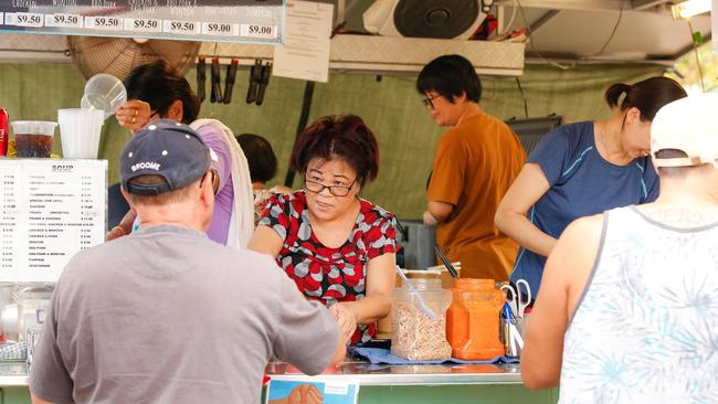 A Mary’s vendor serves up laksa at the Parap Markets. Picture: Glenn Campbell