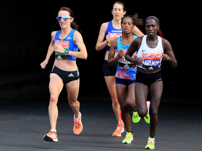 Australia’s Lisa Weightman (left) and champion Kenyan runner Florence Kiplagat compete in the 2017 London Marathon. Picture: Getty Images