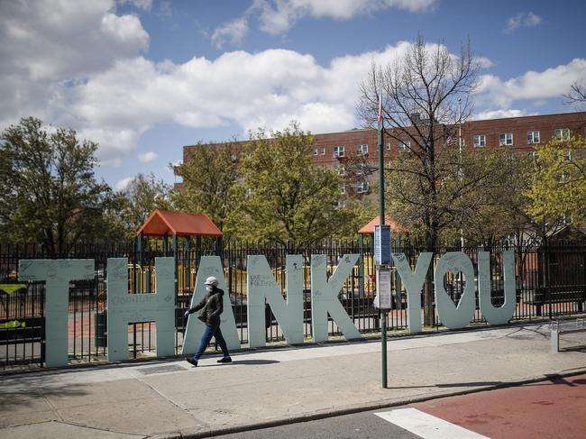 A masked pedestrian walks past a New York hospital. Picture: AP