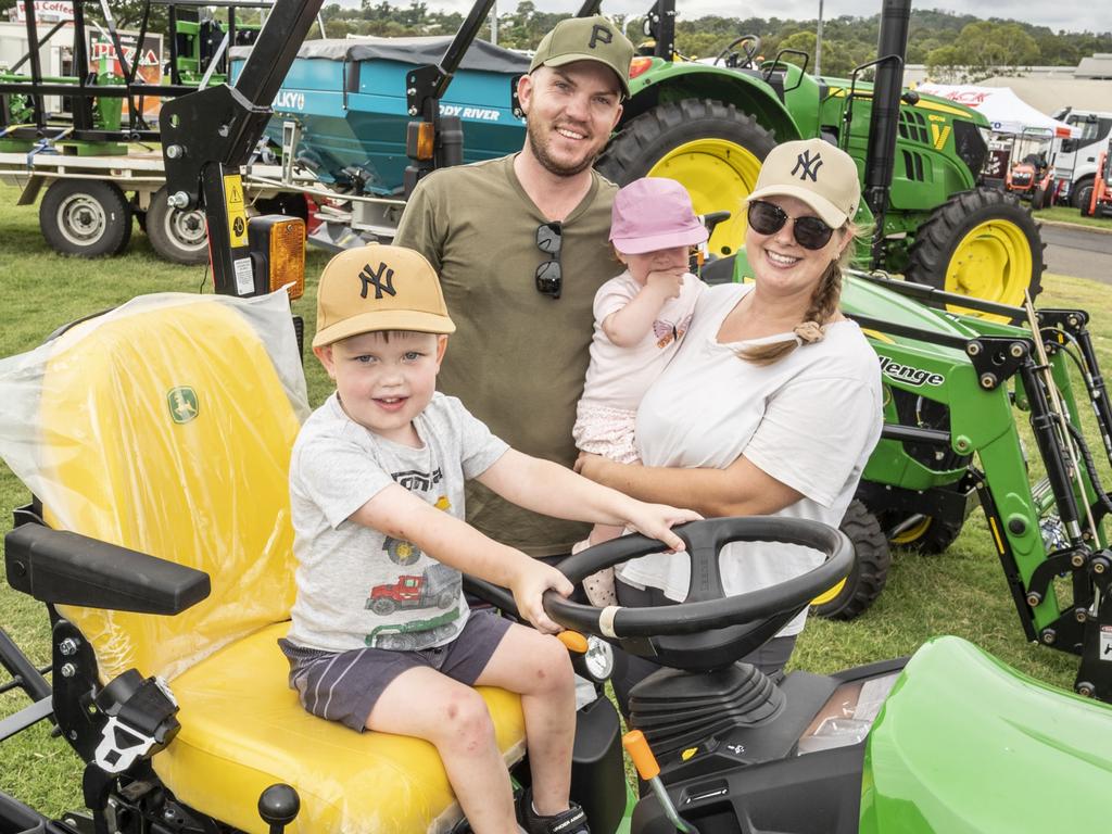 Cooper Goostrey 3yo with Corey, Madelynn and Kate Goostrey checking out the tractor display at the Toowoomba Royal Show. Saturday, March 26, 2022. Picture: Nev Madsen.