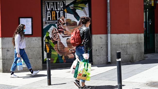 Women wearing face masks carry groceries in Madrid. Picture: AFP