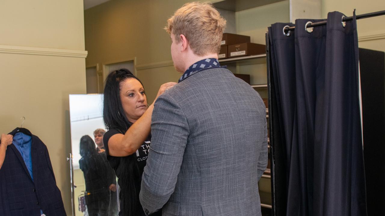 Richmond River Highschool captain Connor McDougall gets fitted for a suit donated to flood-impacted students at the Lismore Showgrounds.