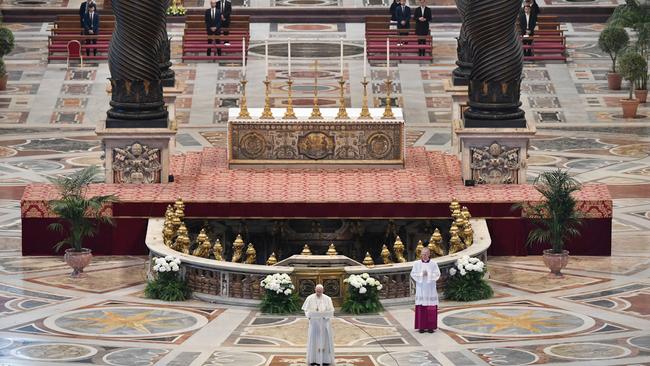 Pope Francis, bottom centre, delivers his Urbi et Orbi message following Easter Sunday Mass behind closed doors at St Peter's Basilica in The Vatican.