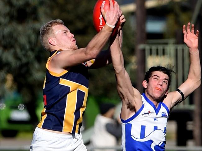 RDFL footy: Sunbury Kangaroos V Rupertswood. Rupertswood no 21 Liam Berry with the ball and Sunbury's 11 Jackson Braddley. Picture: Kylie Else