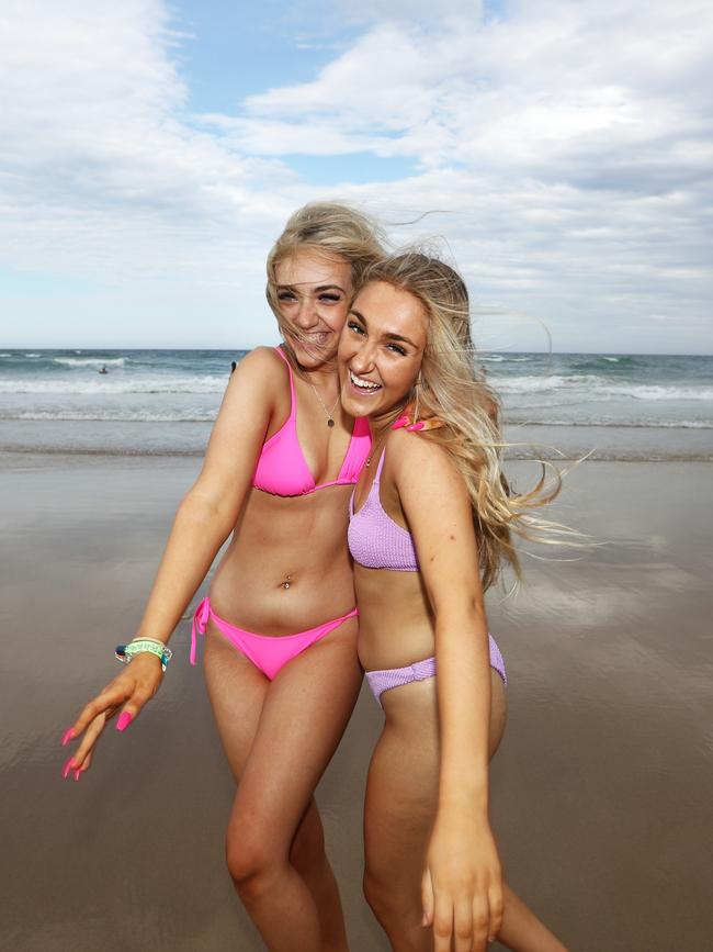 Mount St Michael's Schoolies Maddie Latham (Pink) and Ella Kemp (purple) at Surfers Paradise Beach on The Gold Coast. Photograph: Jason O'Brien / Sunday Mail
