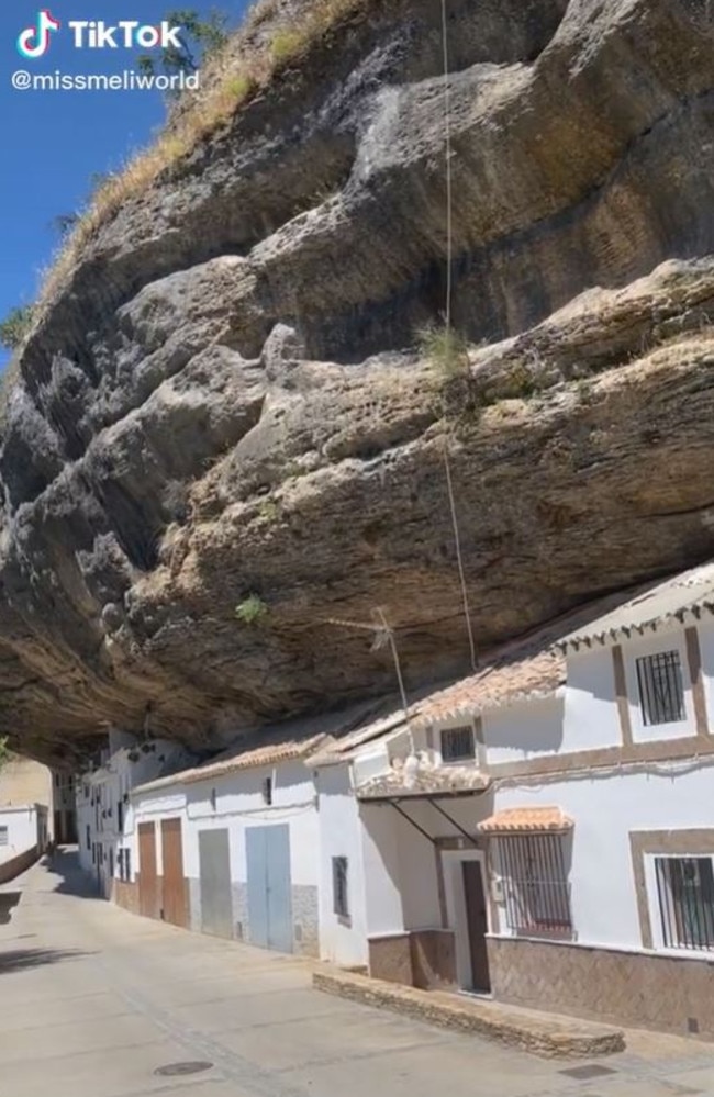 Buildings have a front wall, but the interior simply uses the existing caves underneath the rock overhang. Picture: TikTok/missmeliworld