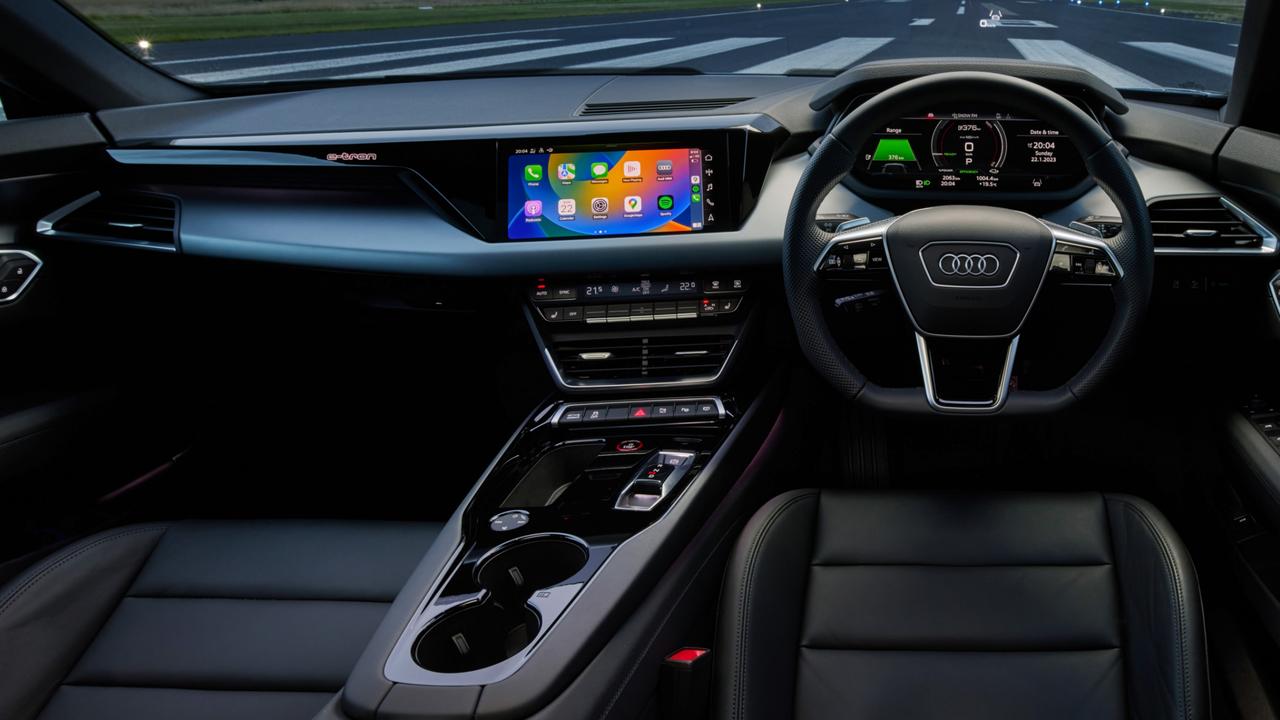 Interior features of the Audi e-tron GT RS include carbon fibre across the dash, leather and suede finishes around the doors, flat-bottom sports steering wheel, nappa leather trim with honeycomb stitching on the front seats.