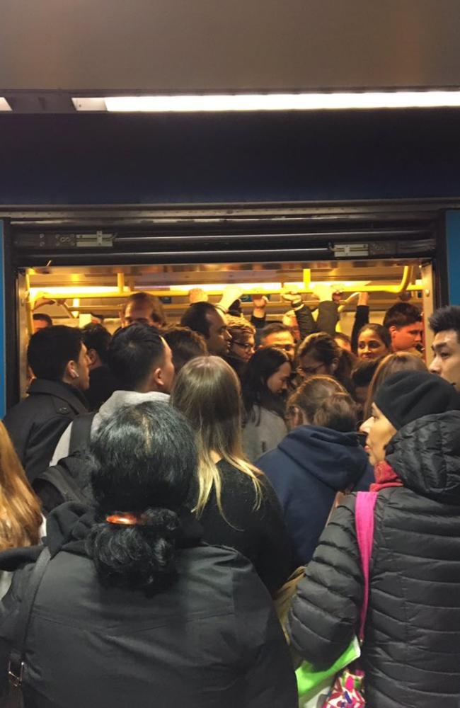 Commuters crush on to a train at Melbourne Central station. Picture: