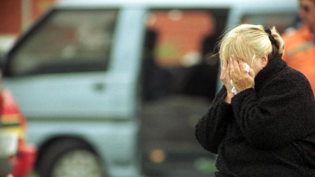 Judy Moran, mother of Jason Moran, cries beside the van in which he was shot dead. Photo: Peter Smith.