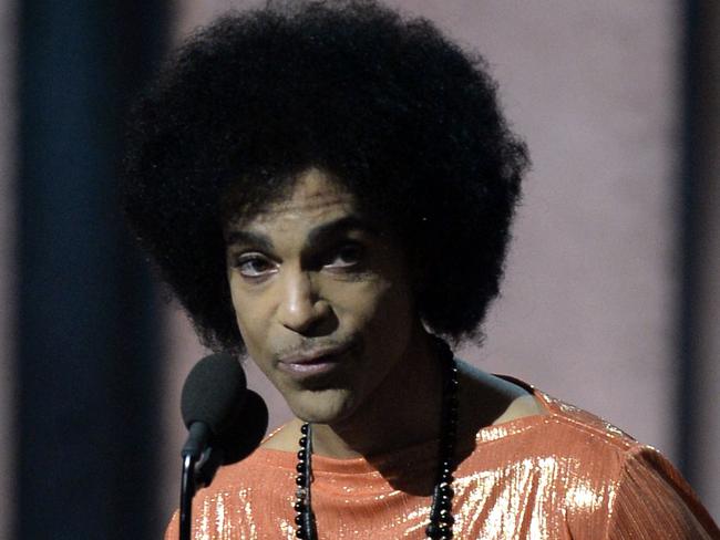 (FILES) This file photo taken on February 8, 2015 shows Prince presets an award on stage at the 57th Annual Grammy Awards in Los Angeles. A New Zealand man is the latest person to say he is pop icon Prince's heir after a judge dismissed a series of other claims, court documents showed on December 5, 2016. A lawyer for the administrator in charge of Prince's estate agreed to arrange genetic testing on Max Stacey McCormack, but made no secret of his doubts about the claim. McCormack, from Invercargill on New Zealand's southern tip, submitted as evidence a photo of a person who had a "mild physical resemblance" to Prince but did not appear to be the "Purple Rain" star, said David Crosby, who represents Bremer Trust. / AFP PHOTO / ROBYN BECK