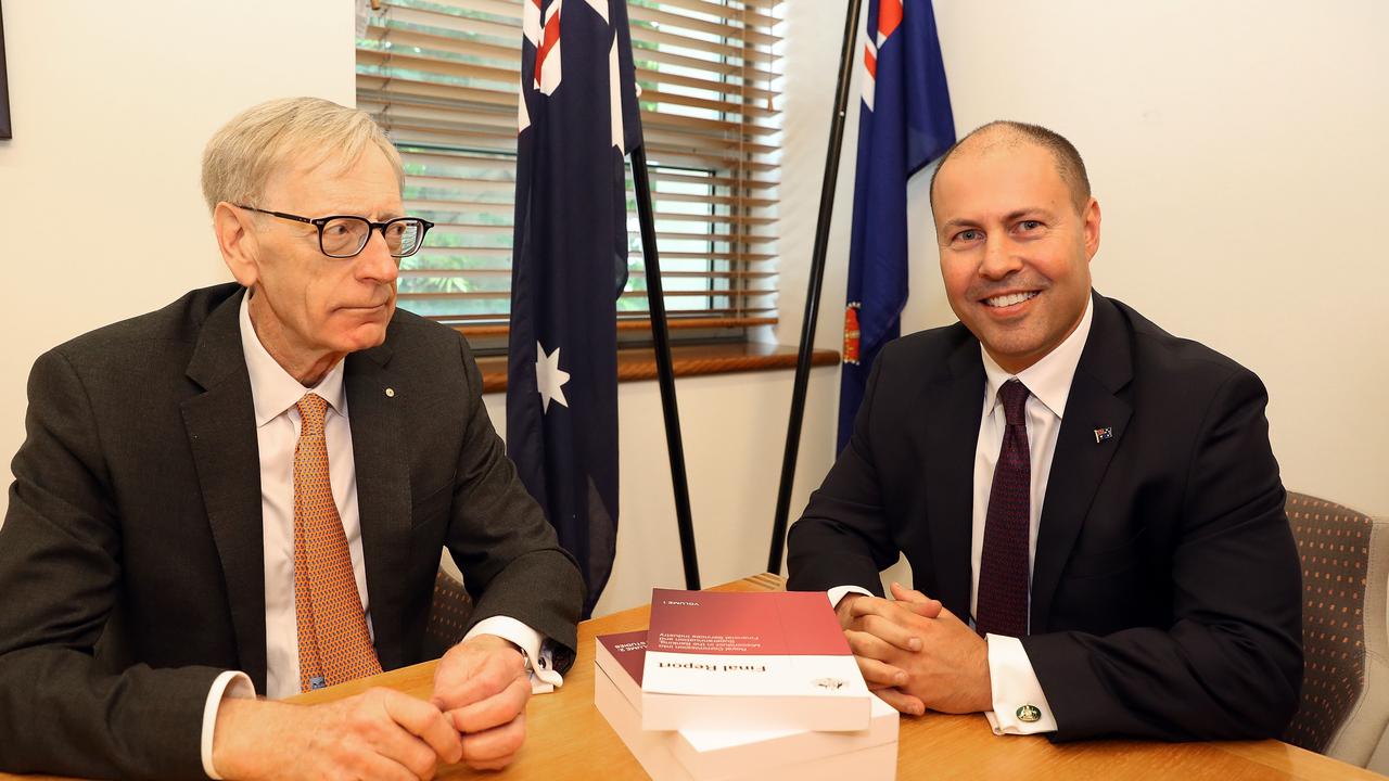 Commissioner Kenneth Hayne handed the final report to Treasurer Josh Frydenberg (right) on Friday, making for an awkward photo. When photographers asked, “Could we get a handshake or something …” Mr Hayne stonily replied, “nope.” Picture: AAP Image/Fairfax Media Pool, Kym Smith