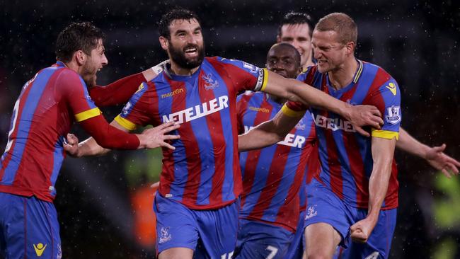 Crystal Palace's captain Mile Jedinak, second left, celebrates scoring his side's third goal with during the English Premier League soccer match between Crystal Palace and Liverpool at Selhurst Park stadium in London, Sunday, Nov. 23, 2014. (AP Photo/Matt Dunham)