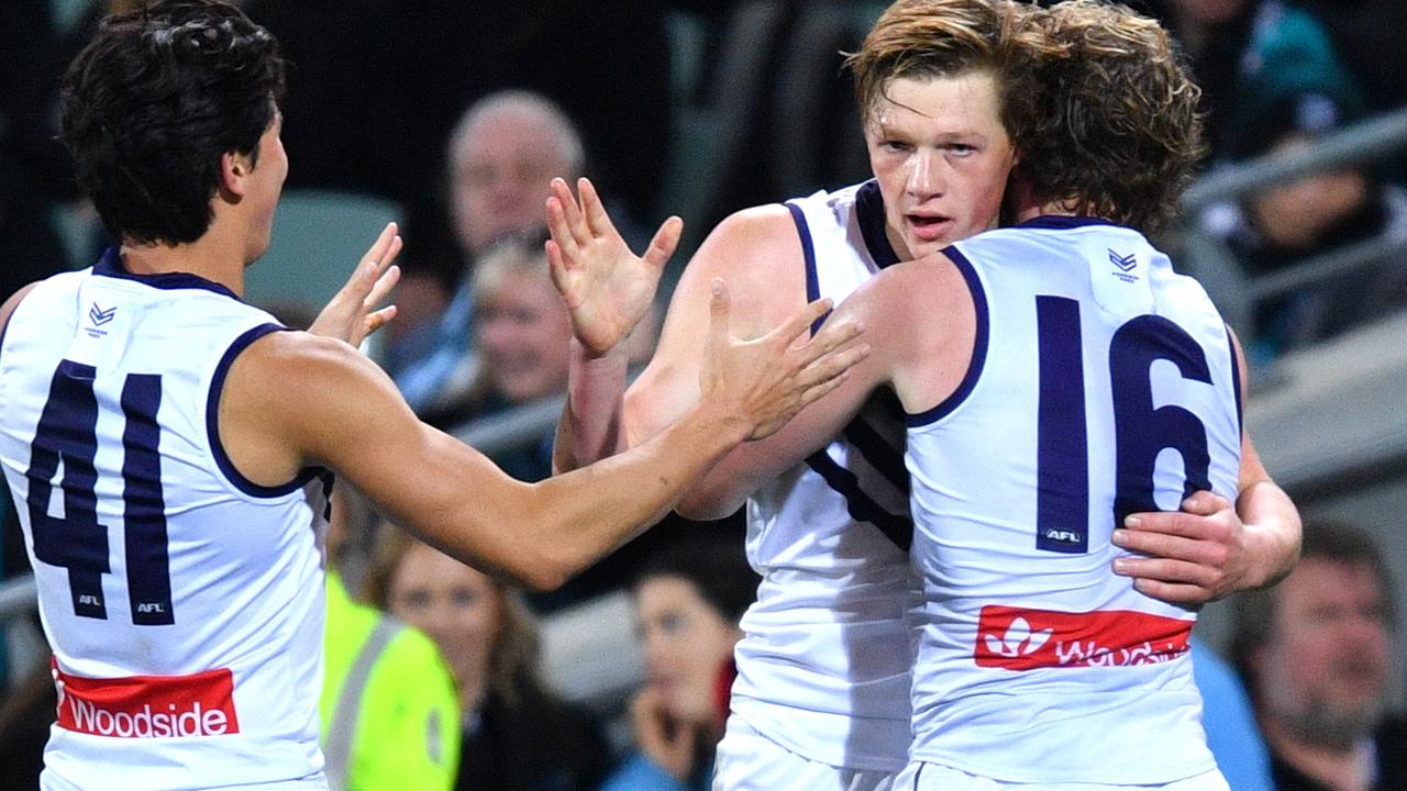 Hugh Dixon of the Dockers celebrates his first goal with team mates during the Round 23 AFL match between the Port Adelaide Power and the Fremantle Dockers at the Adelaide Oval in Adelaide.