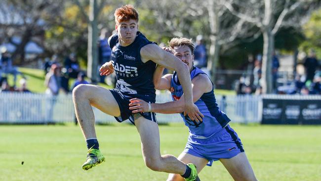 Joseph Haines kicks under pressure from Sturt’s Mani Liddy during the Panthers’ win on Saturday. Picture: Brenton Edwards