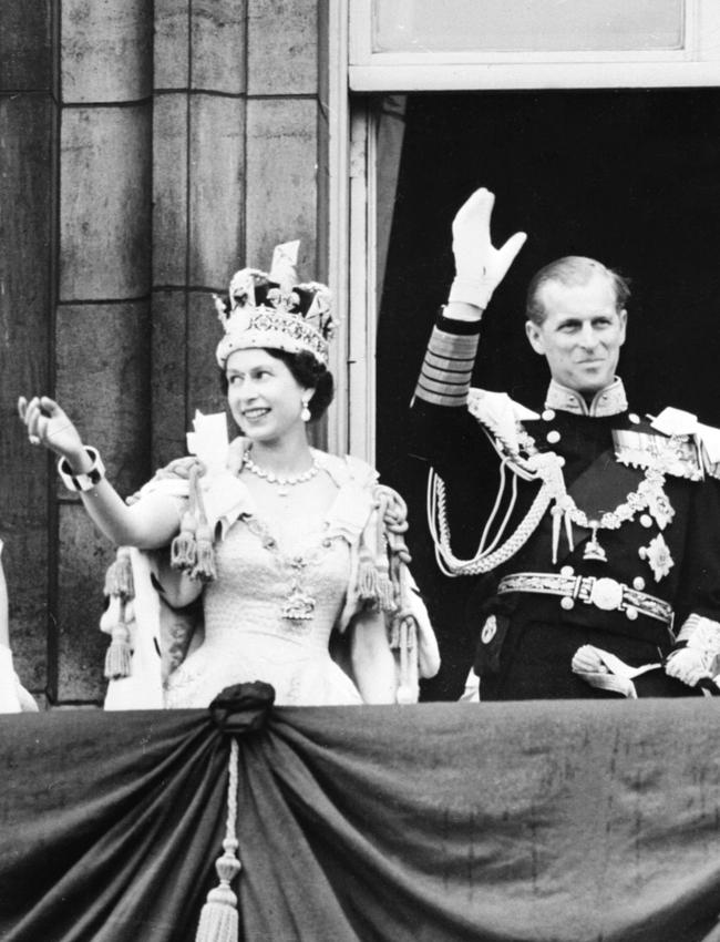 June 2, 1953: Britain's Queen Elizabeth II accompanied by Prince Philip waves to the crowd after being crowned during her coronation at Westminster Abbey in London. Picture: AFP PHOTO / STF