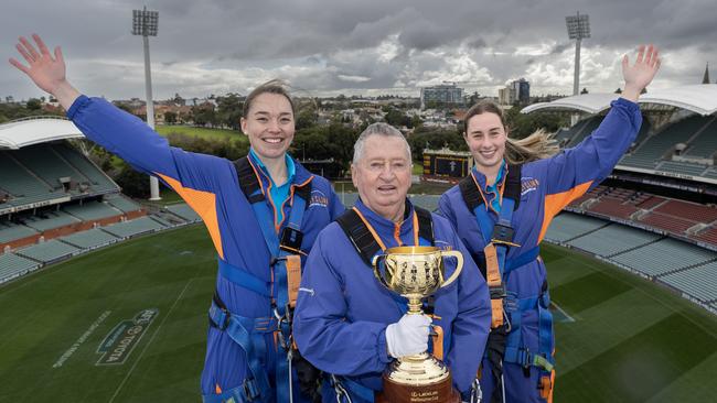 Adelaide, SA: John Letts, dual winner of the Melbourne Cup, alongside WBBL Strikers players Annie O’Neil and Maddie Penna take the Cup to the top of the Adelaide Oval. Picture: Sarah Reed