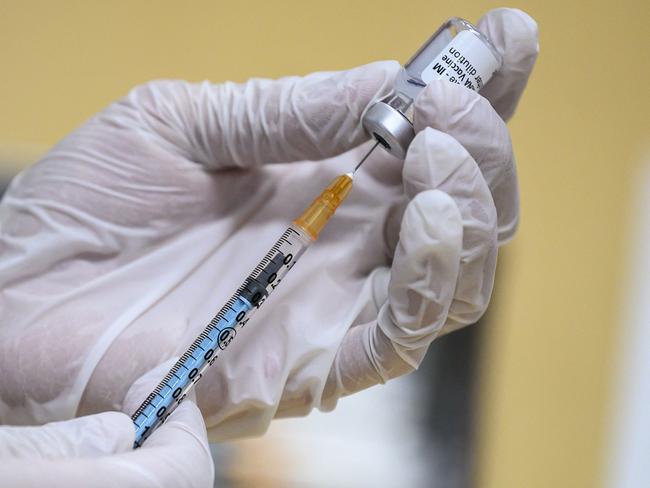 A medical worker fills a syringe with a dose of the Pfizer-BioNTech Covid-19 vaccine as Japan launches its inoculation campaign at the Tokyo National Hospital in Kiyose, Tokyo prefecture on February 17, 2021. (Photo by CHARLY TRIBALLEAU / AFP)